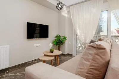 a living room with a couch and a table at Brand New Building Deluxe Apartments With Parking Nearby Train in Athens
