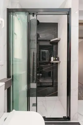 a glass shower in a bathroom with a toilet at Brand New Building Deluxe Apartments With Parking Nearby Train in Athens