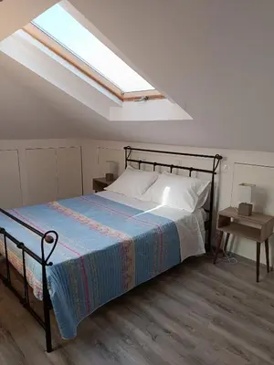 a bedroom with a bed and a skylight at ATH Airport, Loft in Painia in Paianía