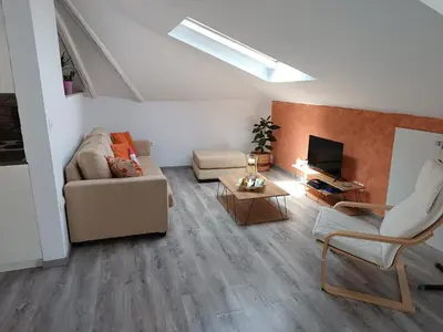 a living room with a couch and a tv at ATH Airport, Loft in Painia in Paianía
