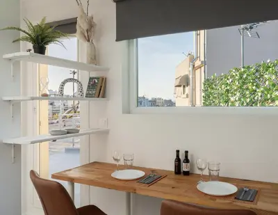 a dining room table with wine glasses and a window at Top Floor Stunning Acropolis View in Athens