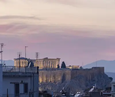 a building on top of a hill with a city at Top Floor Stunning Acropolis View in Athens