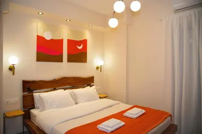 a bedroom with a bed with two towels on it at Sunset Haven Piraeus in Piraeus