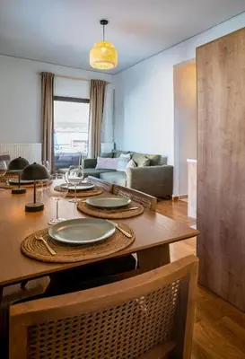 a living room with a table with plates on it at Acropolis Penthouse Project in Athens