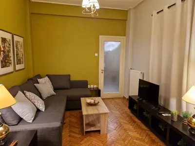 a living room with a couch and a tv at SYGGROU - ONASSIO and REA Hospitals - 1bdr APT - sleep 2-4p in Athens