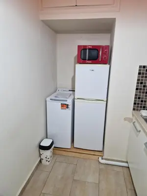 a small kitchen with two refrigerators and a microwave on top at SYGGROU - ONASSIO and REA Hospitals - 1bdr APT - sleep 2-4p in Athens