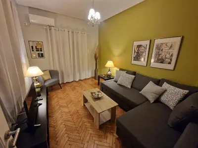 a living room with a couch and a table at SYGGROU - ONASSIO and REA Hospitals - 1bdr APT - sleep 2-4p in Athens