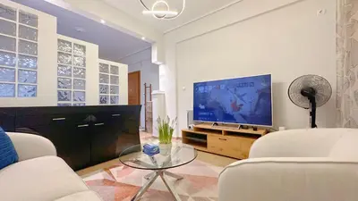 a living room with a tv and a couch and a table at LiI\u7684\u516c\u5bd3\u79bb\u6d771\u5206\u949f Ps5 macPC sony\u7535\u89c6 \u8212\u9002\u5927\u5e8a\u8bb0\u5fc6\u5e8a\u57ab \u6e38\u620f\u5f71\u89c6\u4f11\u95f2\u516c\u5bd3 \u9152\u5e97\u7528\u54c1 in Piraeus