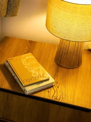 a book sitting on a table next to a lamp at Ariston!Μικρο ρετιρέ στο Θησείο in Athens