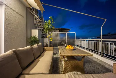 a patio with a couch and a table on a balcony at Ariston!Μικρο ρετιρέ στο Θησείο in Athens