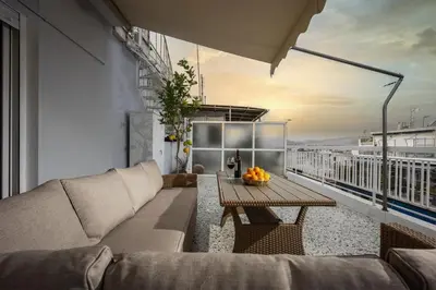 a living room with a couch and a table on a balcony at Ariston!Μικρο ρετιρέ στο Θησείο in Athens