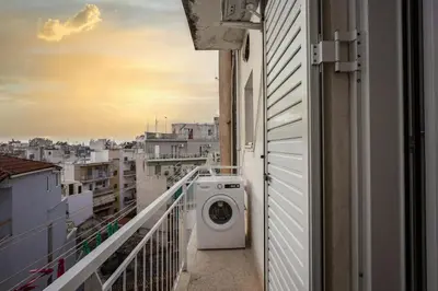 a washing machine on a balcony of a building at Ariston!Μικρο ρετιρέ στο Θησείο in Athens