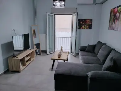 a living room with a couch and a table at MYKALI's COZY APARTMENT in Athens