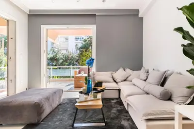 a living room with a large white couch at Eclipse Riviera Cosy in Athens