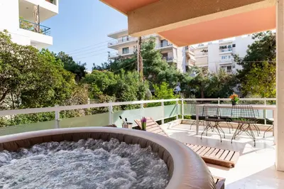 a hot tub on the balcony of a building at Eclipse Riviera Cosy in Athens