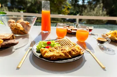 a table with a plate of food and drinks at Eclipse Riviera Cosy in Athens
