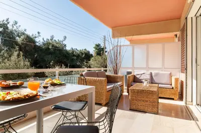 a balcony with a table with food on it at Eclipse Riviera Cosy in Athens