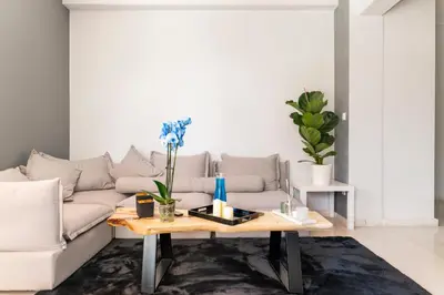 a living room with a couch and a coffee table at Eclipse Riviera Cosy in Athens