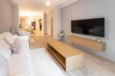 a living room with a large flat screen tv on a wall at Athenian Heaven in Athens