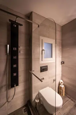 a bathroom with a toilet and a glass shower at Athenian Heaven in Athens