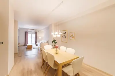 a dining room and living room with a table and chairs at Athenian Heaven in Athens