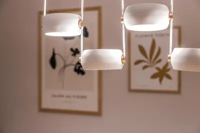 three lights hanging on a wall with two pictures at Athenian Heaven in Athens