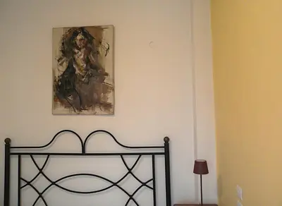 a painting on the wall above a bed in a room at Spacious apartment near Acropolis in Athens