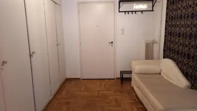 a living room with a couch and a door at Spacious apartment near Acropolis in Athens