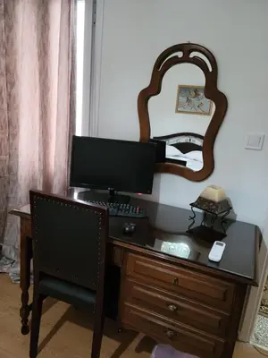 a desk with a computer and a mirror on a wall at Casa Bulu in Athens