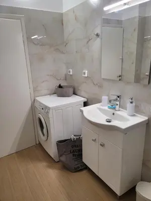 a bathroom with a washing machine and a sink at Casa Bulu in Athens