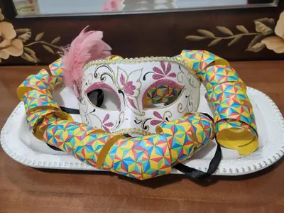 a mask on a plate on a table at Casa Bulu in Athens