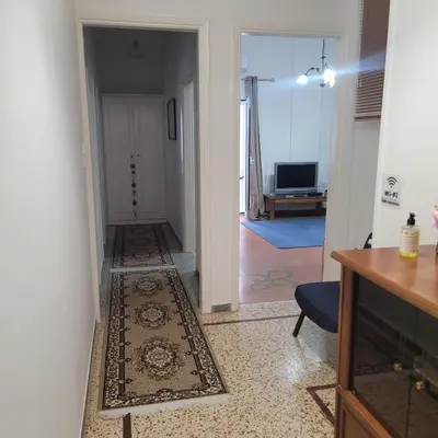 a hallway with a door leading to a living room at Casa Bulu in Athens
