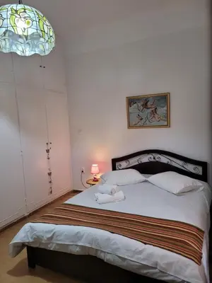 a bedroom with a bed and a stained glass window at Casa Bulu in Athens