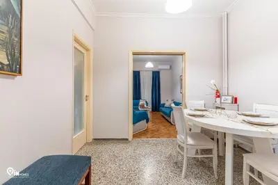 a dining room with a white table and chairs at Sophocles - Central Athenian Cozy Retreat in Athens