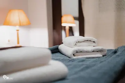 a pile of towels sitting on top of a bed at Sophocles - Central Athenian Cozy Retreat in Athens
