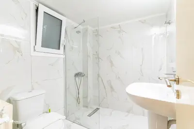 a bathroom with a shower and a toilet and a sink at Sophocles - Central Athenian Cozy Retreat in Athens