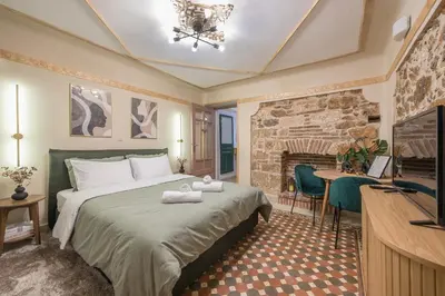 a hotel room with a bed and a fireplace at DP Homes Exarcheia 1B in Athens