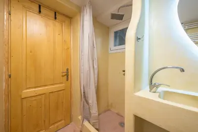 a bathroom with a shower and a sink and a door at DP Homes Exarcheia 1B in Athens