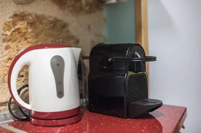 a red and white toaster sitting on top of a counter at DP Homes Exarcheia 1B in Athens