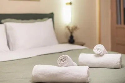 two towels sitting on top of a bed at DP Homes Exarcheia 1B in Athens