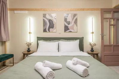 a bedroom with a bed with two towels on it at DP Homes Exarcheia 1B in Athens