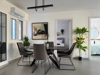 a dining room with a black table and chairs at TH0 Luxury two bedrooms Apartments with High-Tech Amenities in Athens