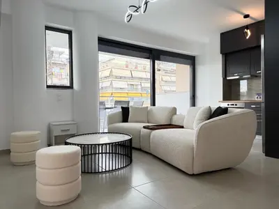 a living room with a white couch and a table at TH0 Luxury two bedrooms Apartments with High-Tech Amenities in Athens