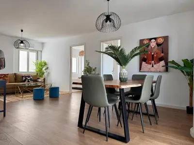 a living room with a dining room table and chairs at TH0 Luxury two bedrooms Apartments with High-Tech Amenities in Athens