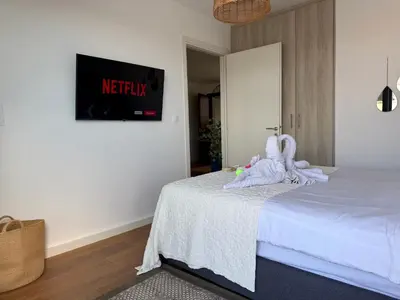 a bedroom with a bed with towels on it at TH0 Luxury two bedrooms Apartments with High-Tech Amenities in Athens