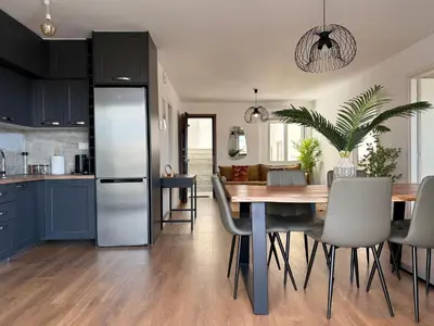 a kitchen and dining room with a table and chairs at TH0 Luxury two bedrooms Apartments with High-Tech Amenities in Athens