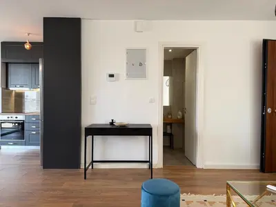 a kitchen with a black table in a room at TH0 Luxury two bedrooms Apartments with High-Tech Amenities in Athens