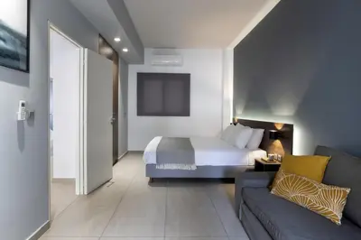 a hotel room with a bed and a couch at Renovated 3BDR Apartment in the heart of Athens in Athens