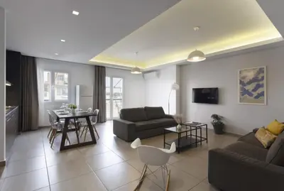 a living room with a couch and a table at Renovated 3BDR Apartment in the heart of Athens in Athens