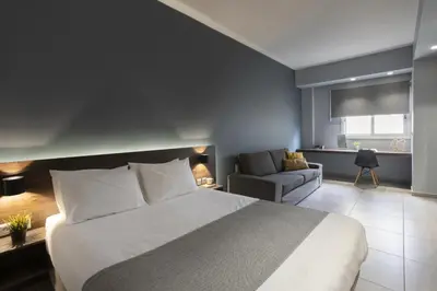 a bedroom with a bed and a living room with a couch at Renovated 3BDR Apartment in the heart of Athens in Athens